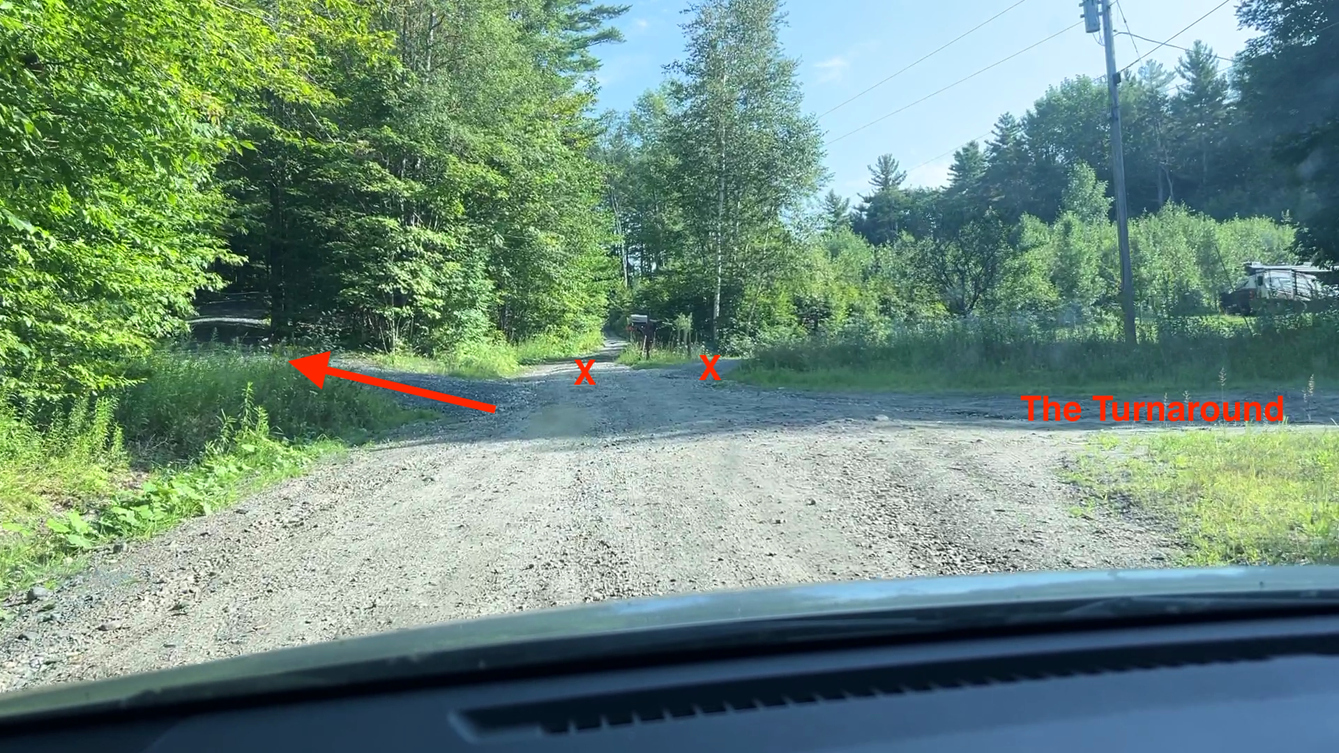 Turnaround with three driveways; take the leftmost gravel driveway